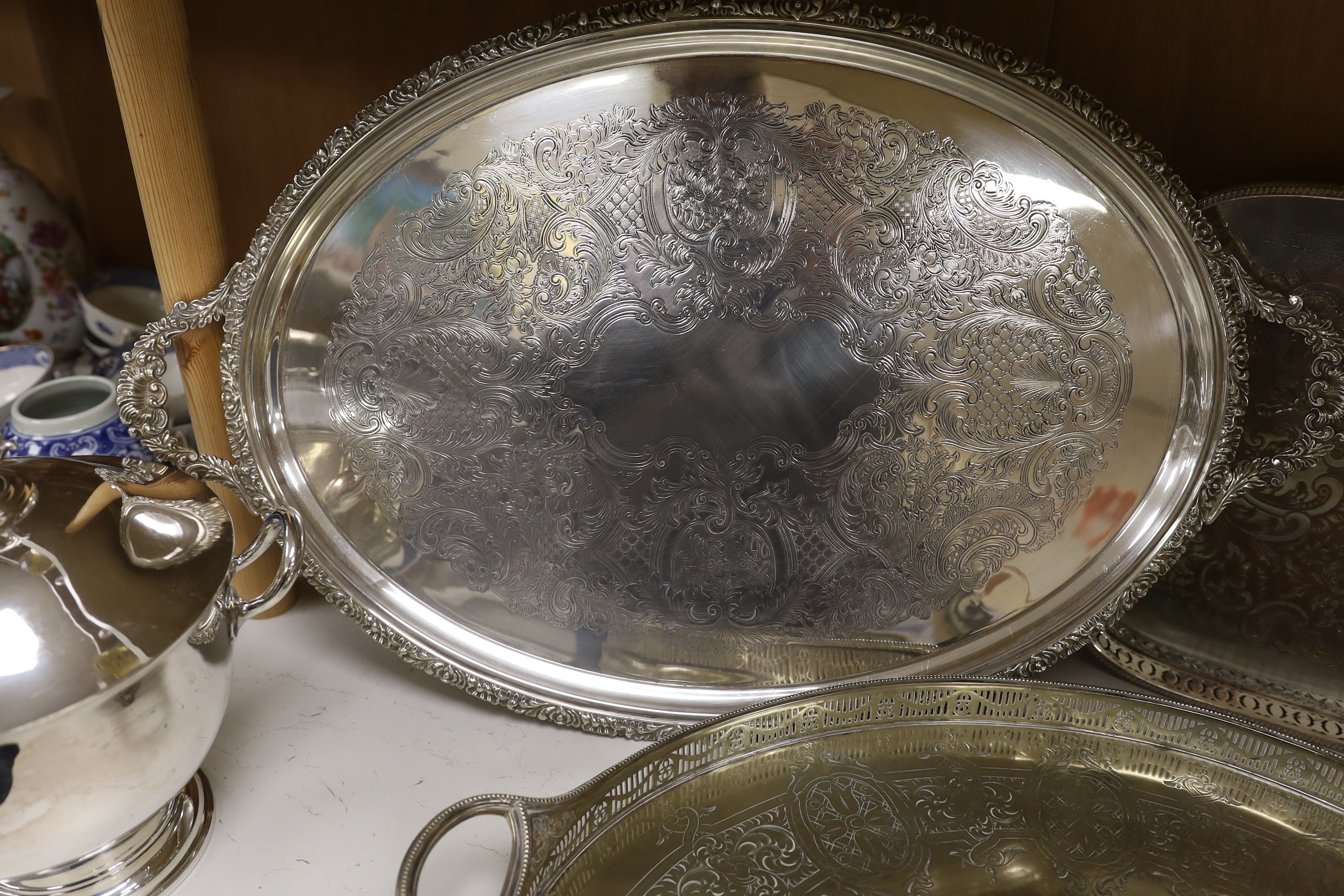 Four items of plated wares; a Victorian galleried tray, a soup tureen and two other trays, largest tray 67cm